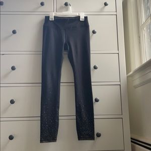 Gaiam black leggings with gold detail.